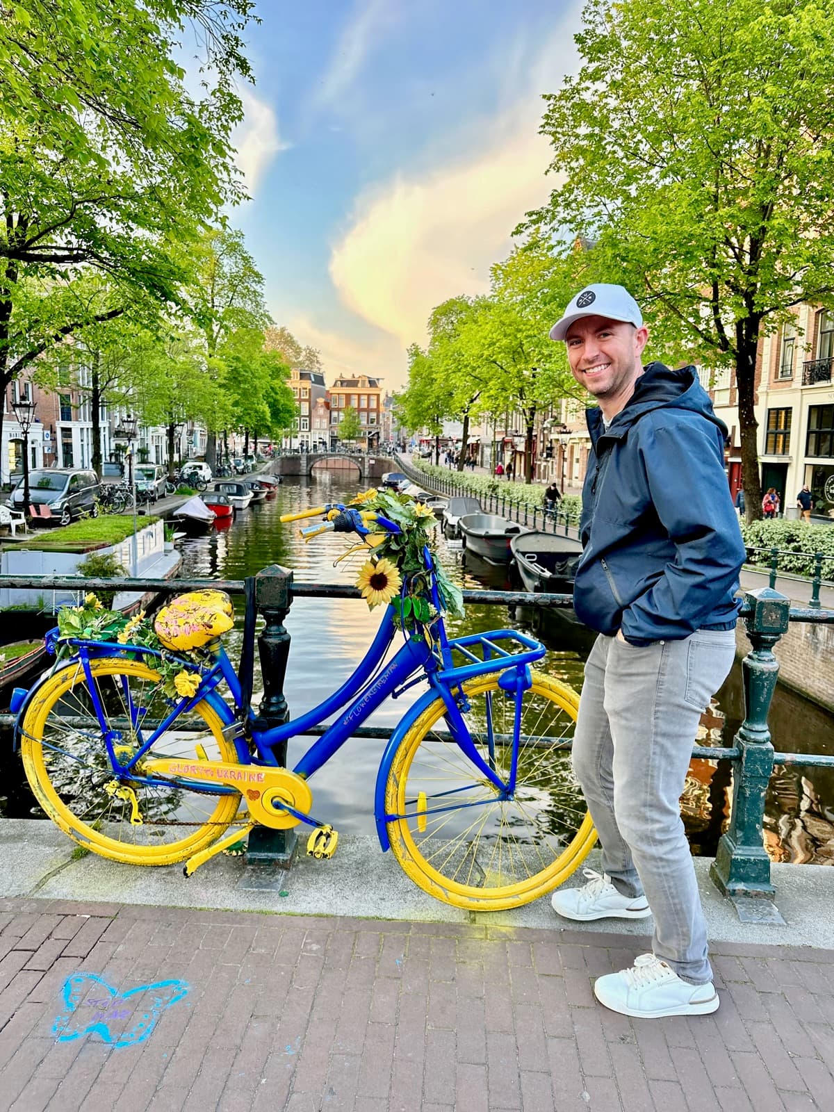 Brett on a canal bridge in Amsterdam at golden hour