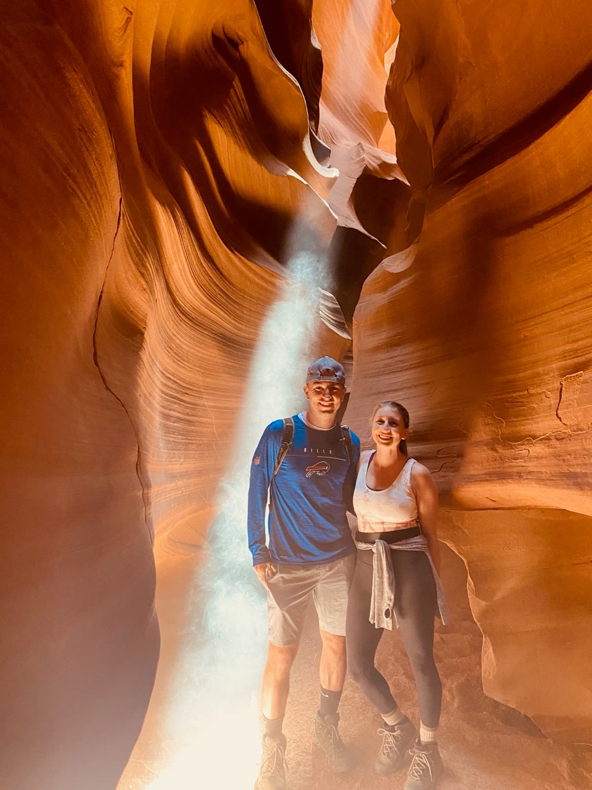 Brett and Erin under a light beam in Antelope Canyon