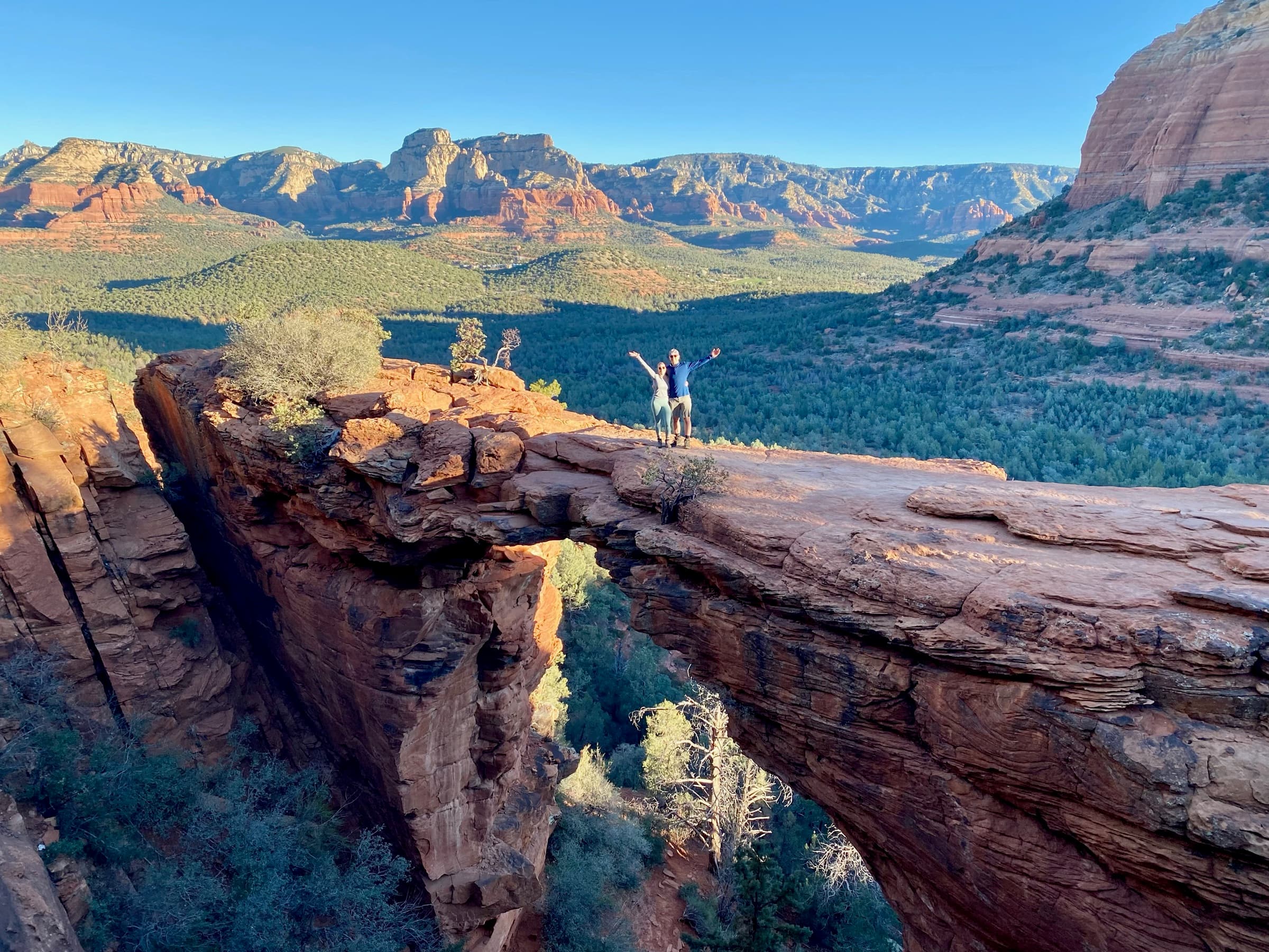 Brett and Erin with arms raised on Devil's Bridge in Sedona