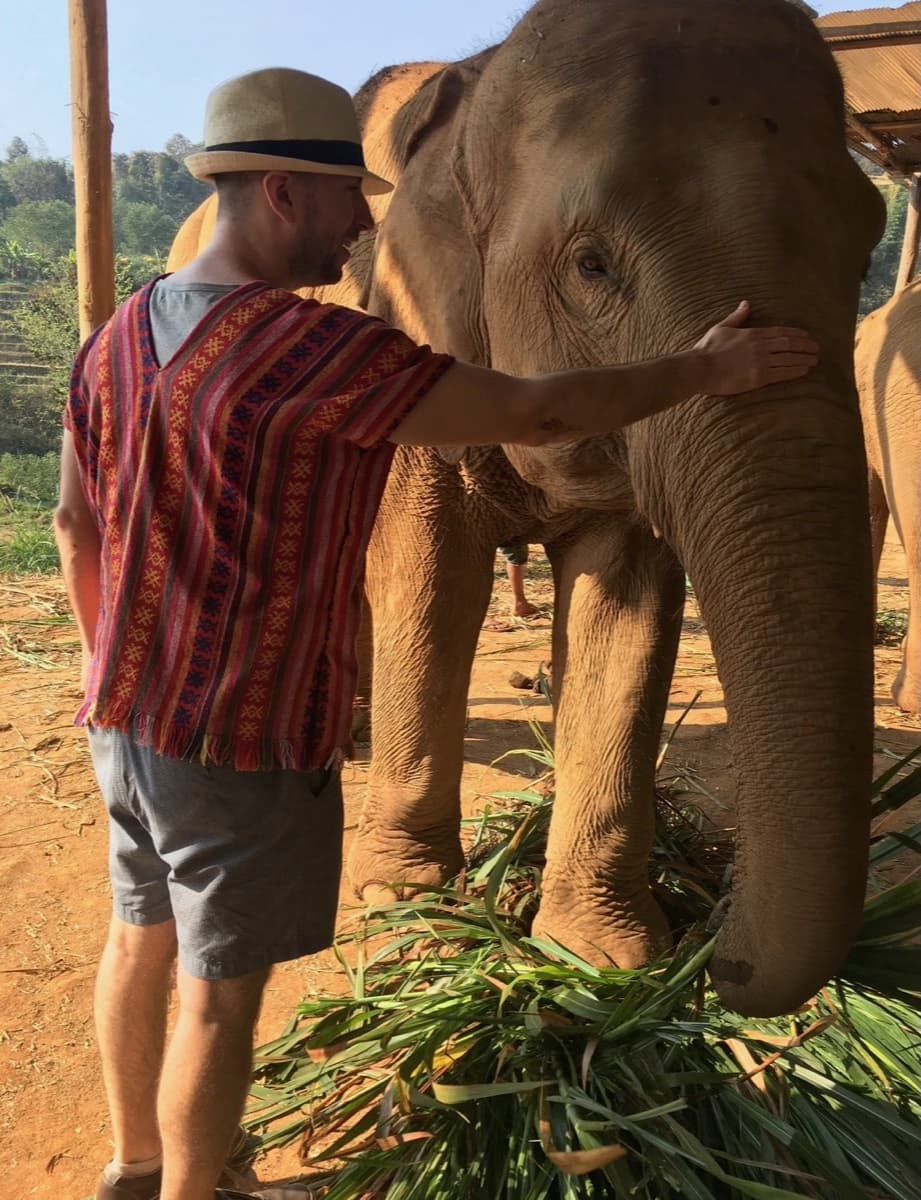 Brett with an elephant at a sanctuary in Thailand
